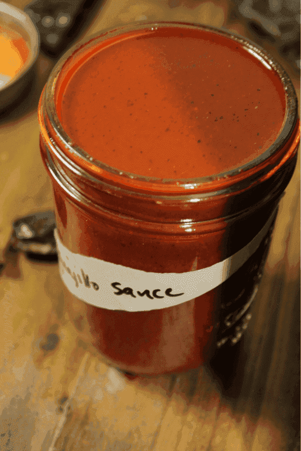 This simmered guajillo chile sauce has a deep, rich flavor that is amazing in enchiladas, over burritos, or even drizzled on tamales.