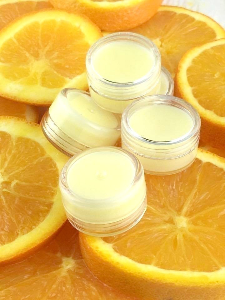 Dry lips? Whip up this DIY Orange Creamsicle Lip Balm with orange and vanilla. It's easy to make and keeps your lips beautifully nourished!