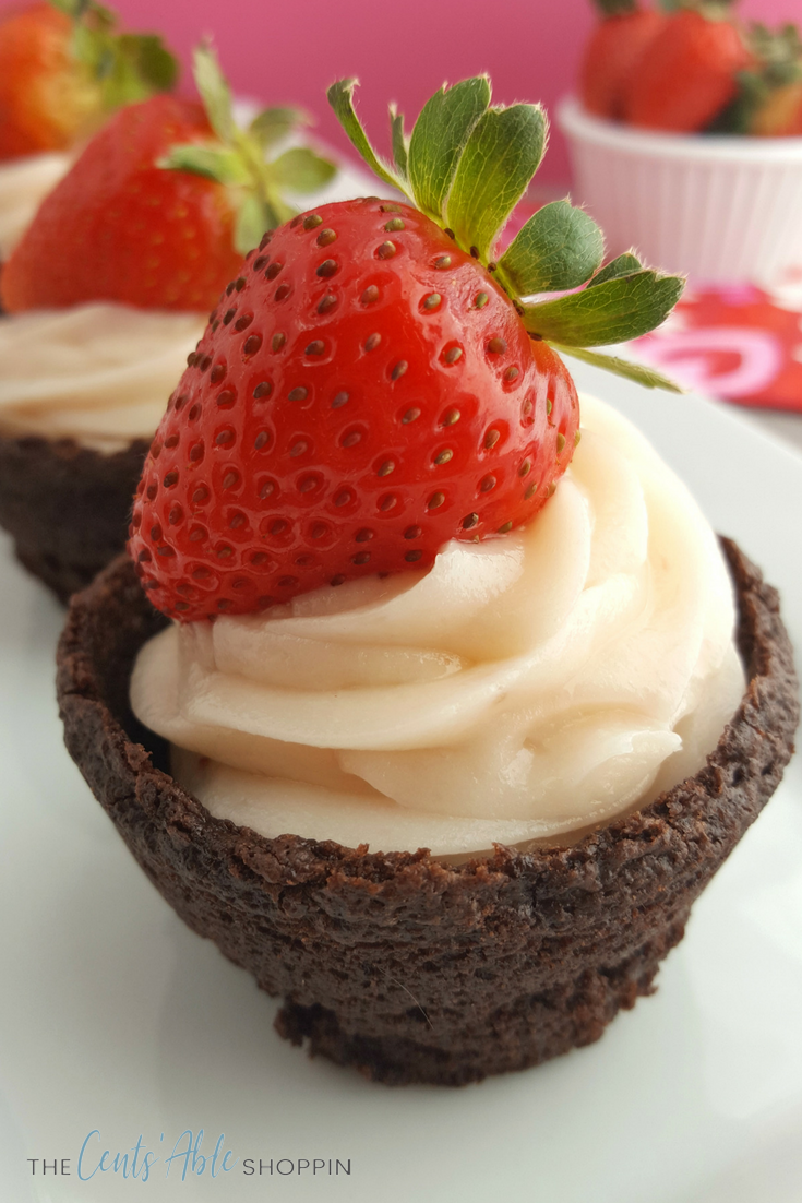 Combine strawberries with yummy cheesecake and brownies to make an adorable festive brownie cup dessert perfect for Valentine's Day! #strawberries #valentine #valentinesday #cheesecake