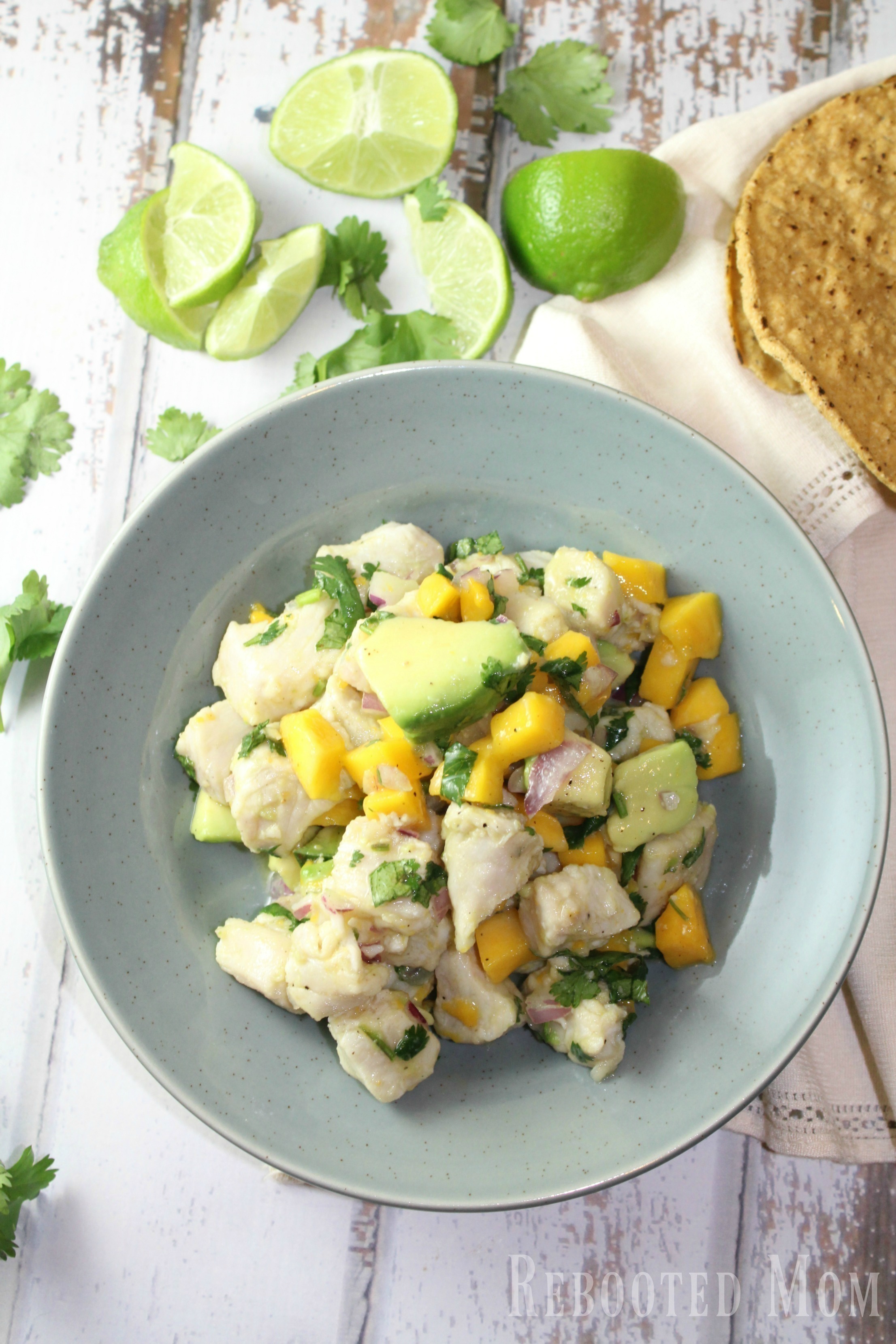 Tropical Mango Ceviche - Rebooted Mom || This tropical mango ceviche uses lemon or lime juice with mahi mahi fillets to cook the fish (through the acidic marinade) in just under 45 minutes. It's delicious!