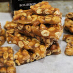 This Bourbon Peanut Brittle is a combination of salty and sweet and a perfect snack to make at the holidays for a party tray that's sure to please!