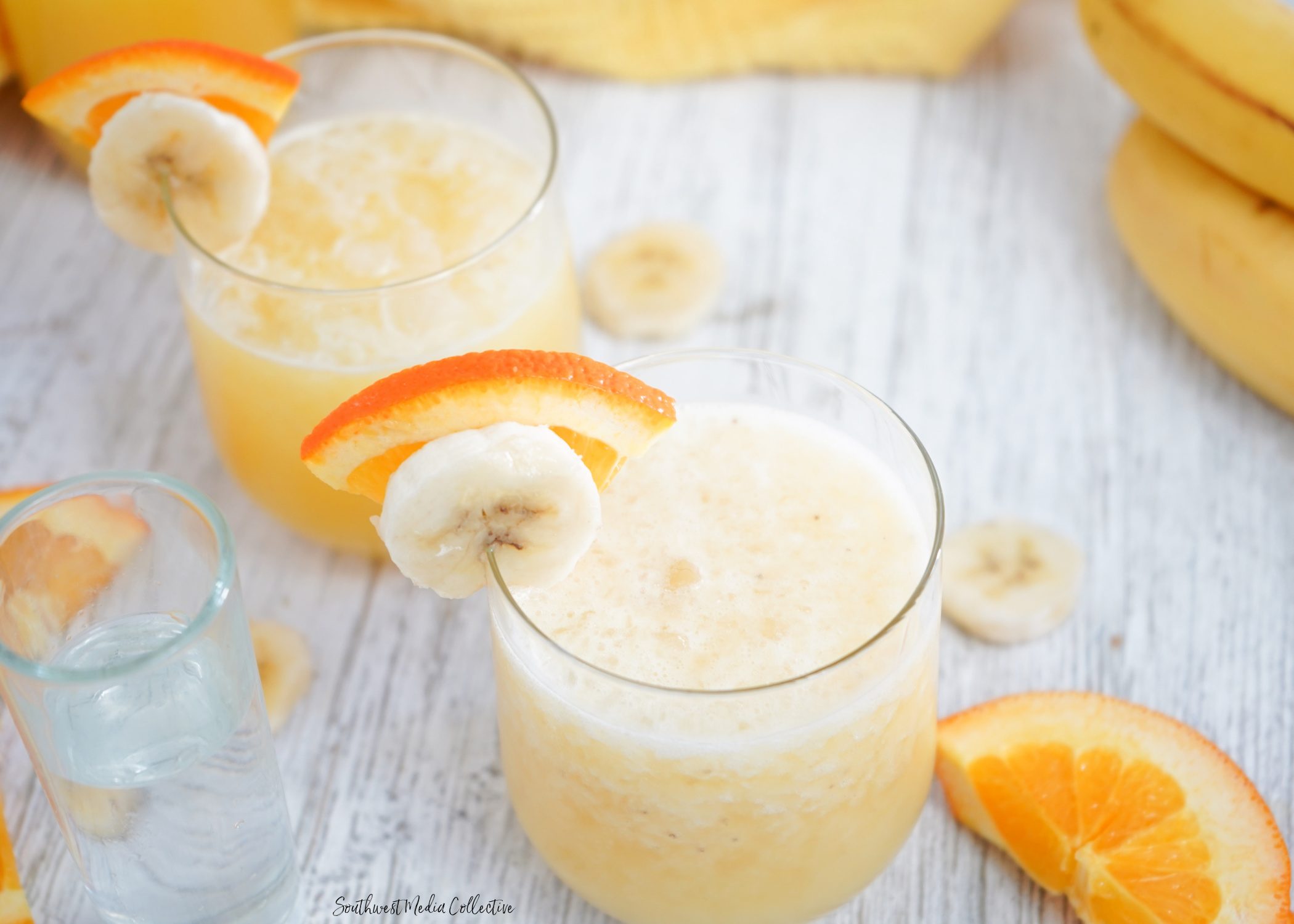 Tipsy Banana Cocktail made with 4 ingredients that come together with ice for a bright and cheery cocktail to bring on warmer weather!