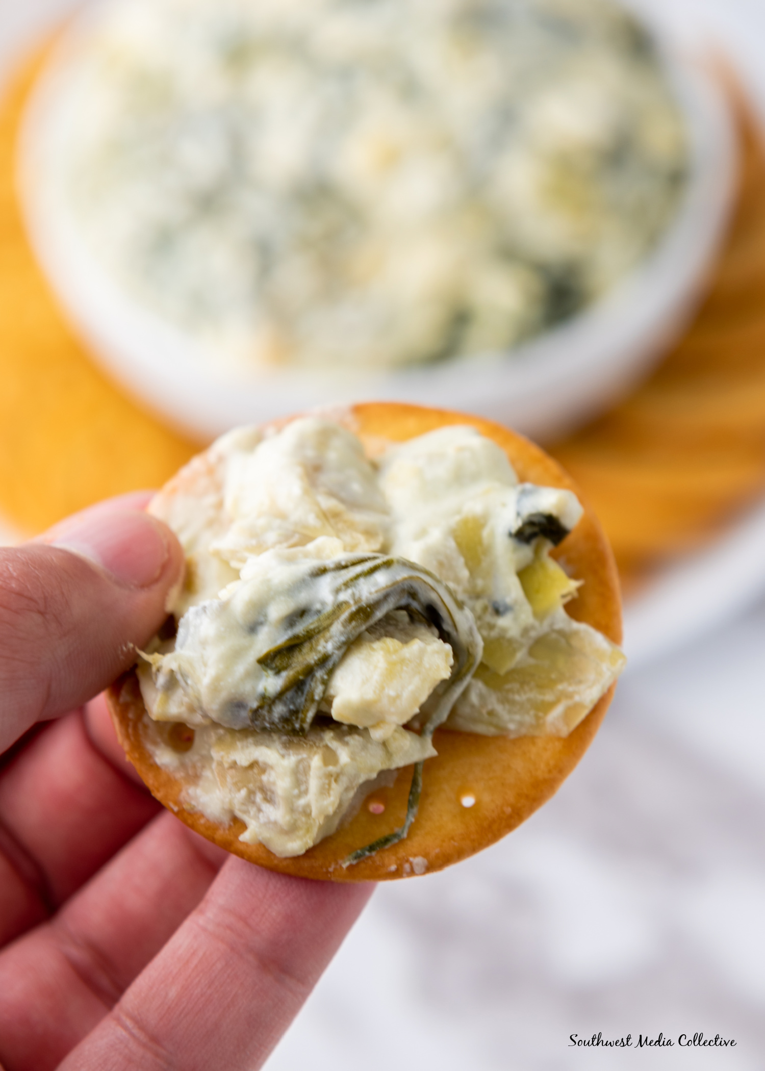 Slow Cooker Spinach Artichoke Dip is always a favorite at parties and get togethers. Make it with just a few simple ingredients in your slow cooker or crockpot for an easy way to feed a crowd.