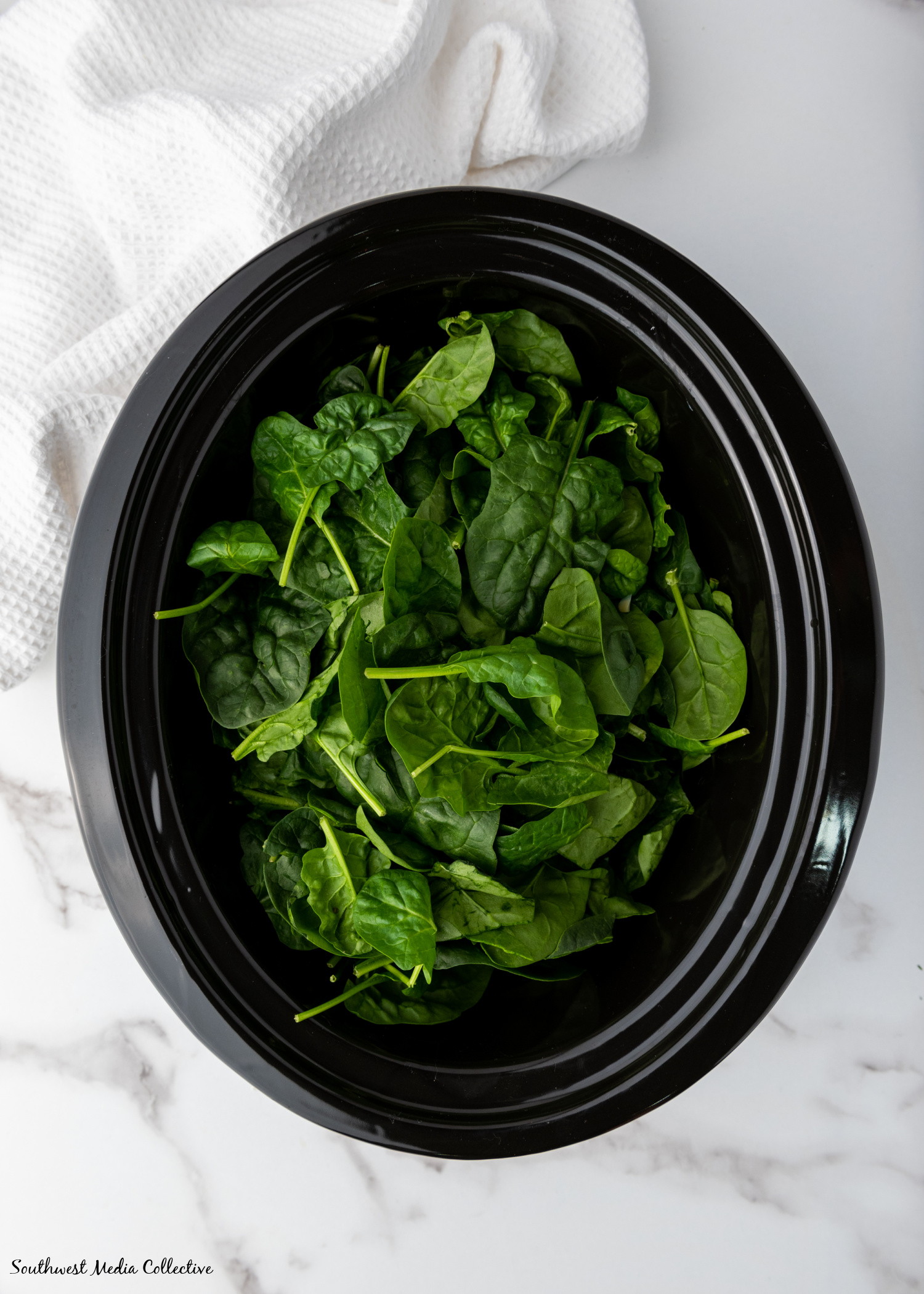 Slow Cooker Spinach Artichoke Dip is always a favorite at parties and get togethers. Make it with just a few simple ingredients in your slow cooker or crockpot for an easy way to feed a crowd.