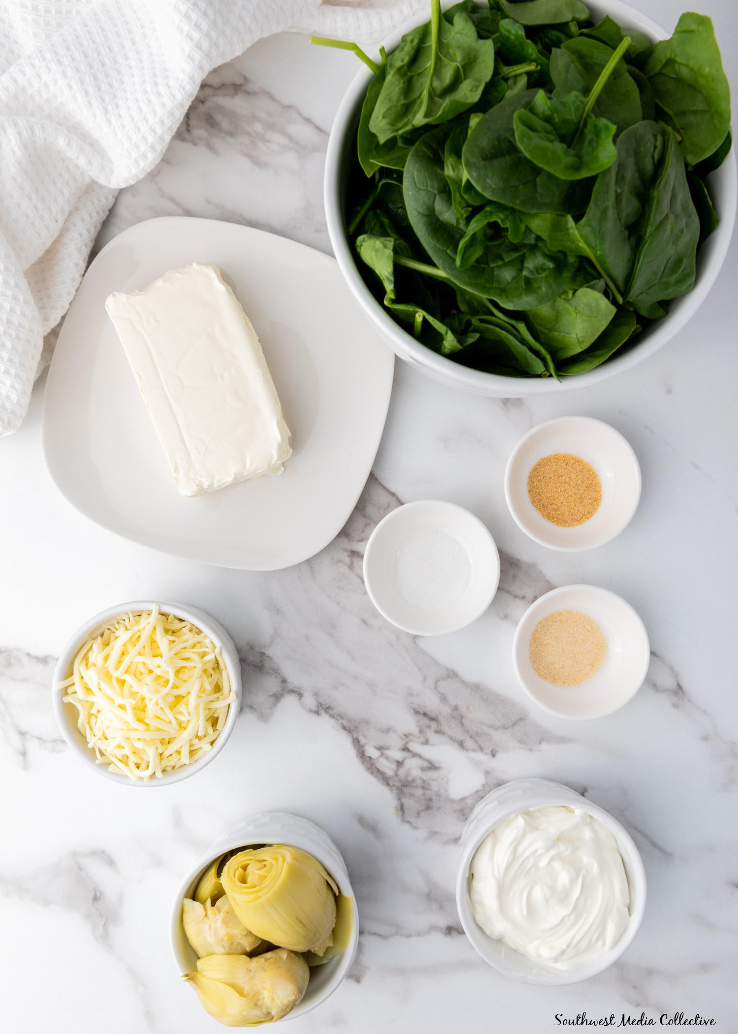 Slow Cooker Spinach Artichoke Dip is always a favorite at parties and get togethers. Make it with just a few simple ingredients in your slow cooker or crockpot for an easy way to feed a crowd.