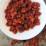 Step by step directions to help you dehydrate cherry tomatoes - the result is a tasty, burst of flavor that can be used in salads, wraps, bread and more!